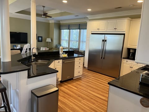 Kitchen featuring stainless steel appliances including commercial fridge/freezer