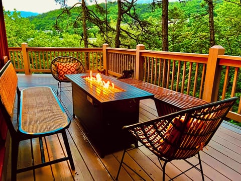 Relax outside on the deck while enjoying the cozy warmth of the fire pit.
