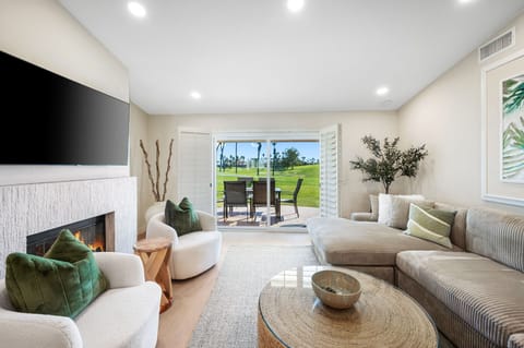 Spacious living area features an oversized, ultra-comfy sectional, smart TV.