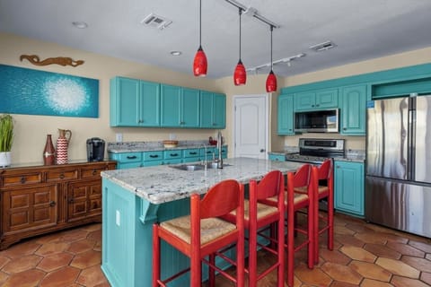 One of three kitchen areas, your main kitchen is fully stocked and has a large center island with state-of-the-art gourmet appliances.