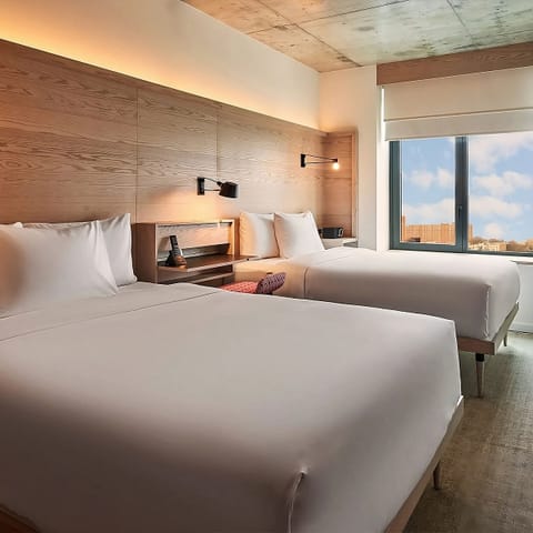 Drift off beside city views and soft, ambient lighting.