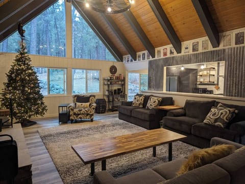 Cozy up in our spacious living room featuring a seasonal tree and a Smart TV