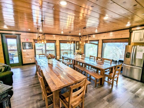 Dining area with 2 large dining table with plenty of windows. 