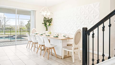 Elegant dining area with modern decor, pool view, and stylish lighting for a perfect dining experience.