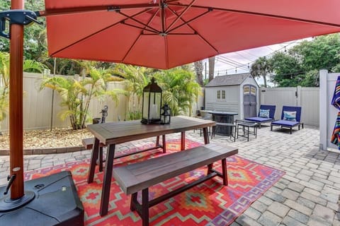 Private Fenced String-Lit Yard with Dining Table and Fire Pit