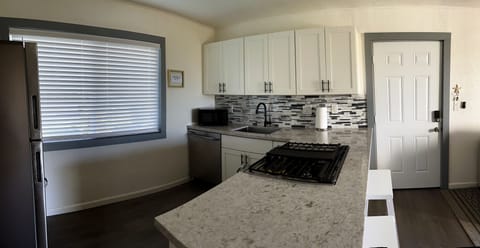 Large sized kitchen area with 5 burner gas range + oven. 