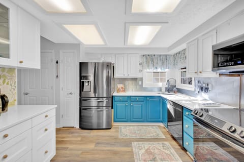 Fully stocked kitchen with stainless steel appliances.