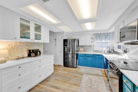 Fully stocked kitchen with stainless steel appliances.
