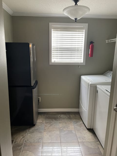 Laundry Room adjacent to the kitchen, includes two mini fridges