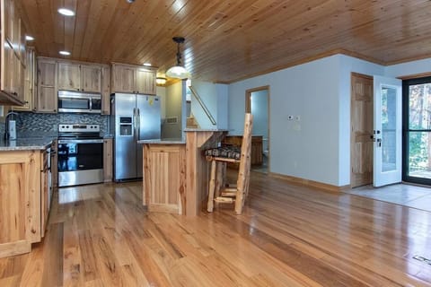 Open floor plan of living, dining and kitchen with one full bath off kitchen.