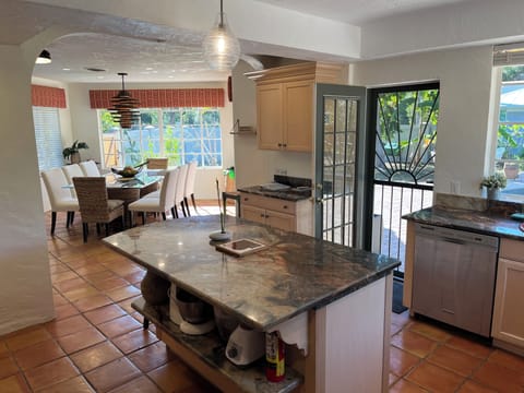 Kitchen looking into dining room and out to pool area.