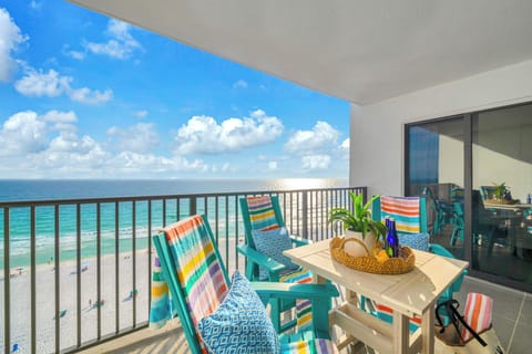 Soak up stunning gulf views from your private balcony, where colorful chairs await lazy afternoons and the endless water stretches before you.