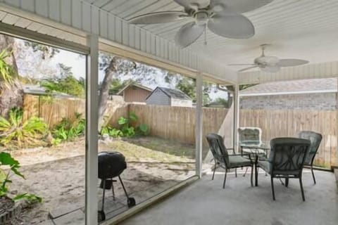 Screened Porch Area with Patio Furniture and Grill
