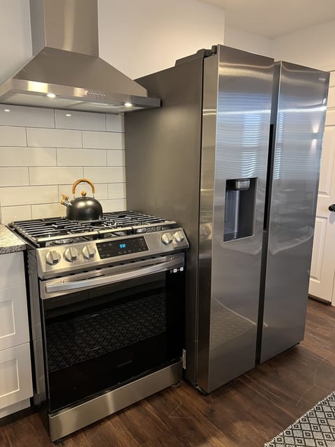 Kitchen with gas range, refrigerator with filtered water/ice