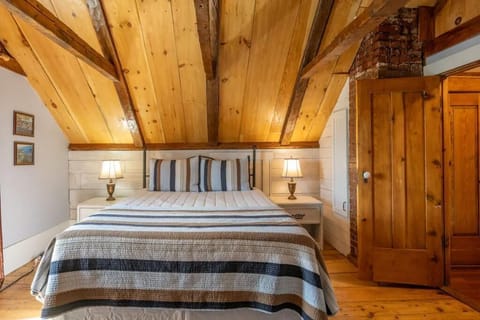 Main Bedroom, original hand hewn beams, Queen size bed and memory foam pillows.