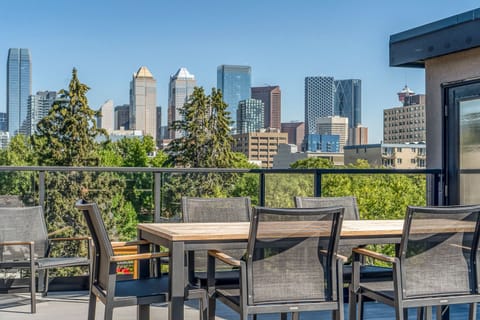 Top deck with view of downtown Calgary. Seating for 8 with high-top dining.