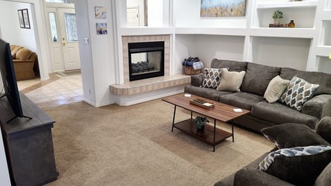 Living room - 55" TV, 2 sided fireplace, sofa & loveseat