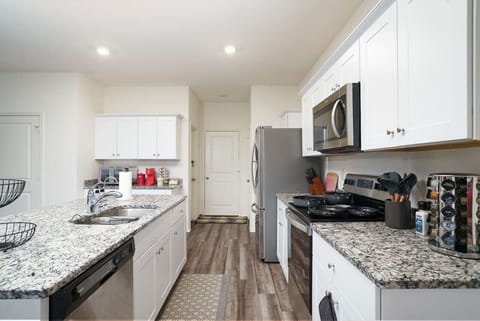 Large space rich kitchen with plenty of cabinets and all kitchen utensils