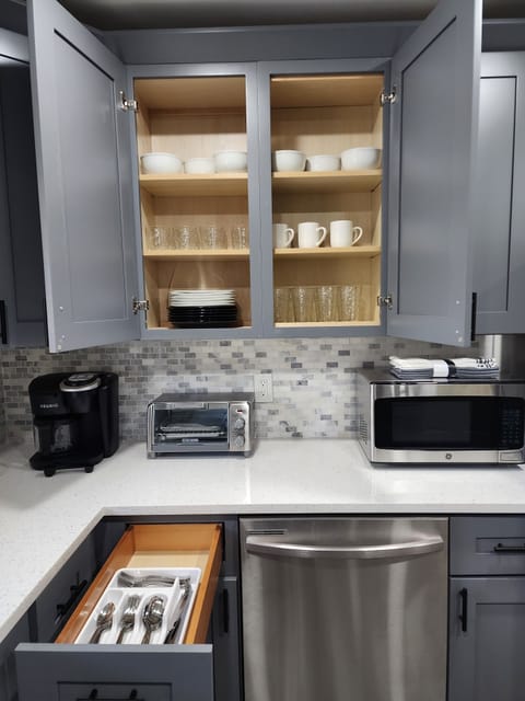 Kitchen equipped with all the essentials including a Keurig, microwave and toaster oven