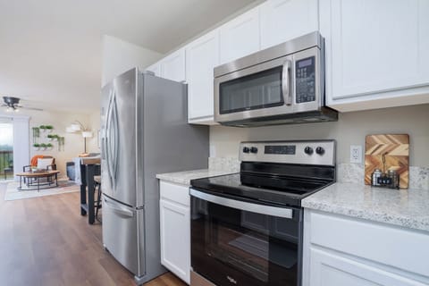 A perfect blend of natural beauty and contemporary design in this kitchen with wooden floors and a black island.