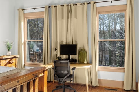 Bedroom #1 Primary Bedroom w/King bed, desk, & office chair overlooking backyard; Main Floor (8)