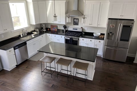 Fully stocked kitchen has ample dishes, glasses, silverware, bowls, pots and pans for quick food on the run or full meals.