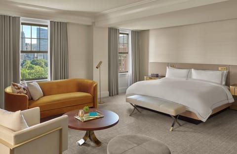 Unwind in a sunlit suite with plush bed and views