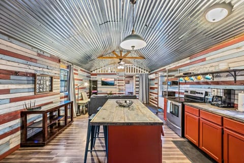 Kitchen island/bar in the center of the space provides  food prep area and additional seating.