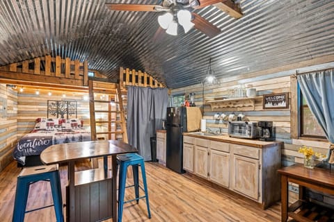 Dining table with two chairs and a convenient kitchen area.