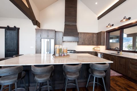 Fully-Stocked Kitchen with Island for Breakfast Bar Seating, Modern Appliances, and Ample Counter Space