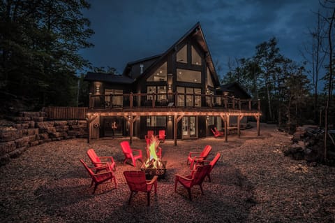 A picturesque view of the fire pit area during the evening, showcasing the beautiful natural surroundings and the comfortable seating arrangement.