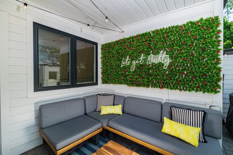 📷The ultimate photo op: “Let’s Get Nashty” neon sign framed by lush faux greenery—your IG feed just leveled up.