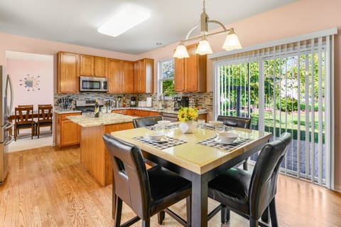 Stocked kitchen with cookware, and with dinnerware for 12. Breakfast table and walk-out to backyard