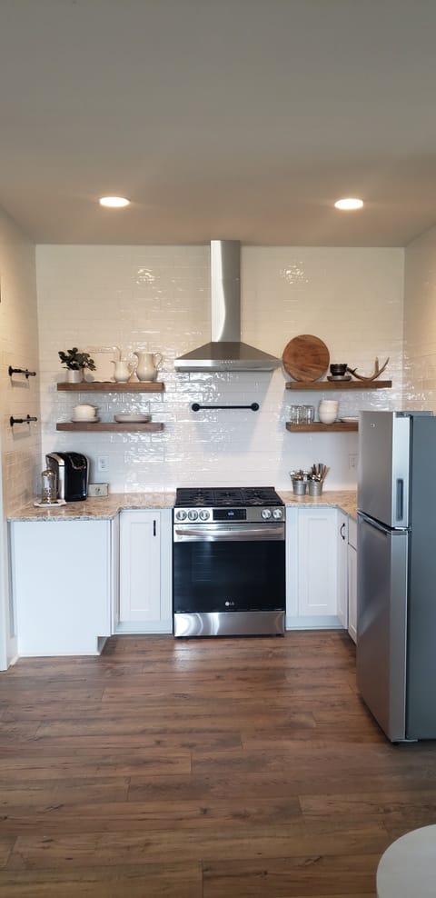 Kitchen with range, fridge, and sink.