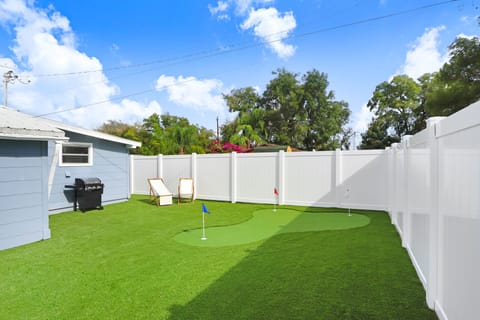 Backyard equipped with grill and putting green. Putters and golf balls provided.