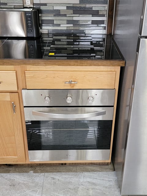 Induction cooktop conventional stove full size refrigerator microwave granite.