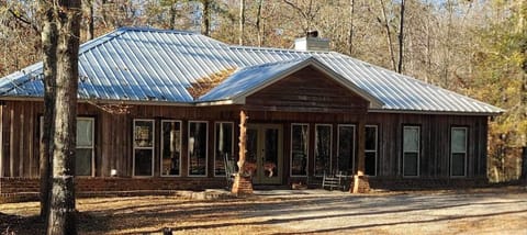 Front of the cabin. Cypress wood exterior. Front porch perfect for rocking. 