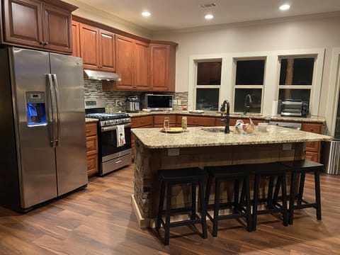 Kitchen island with a small sink and bar stools for 4.