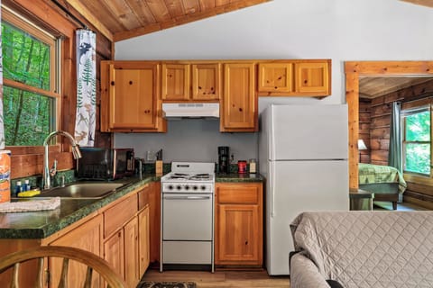 Whip up breakfast or a cozy dinner with a fully stocked kitchen and forest views.