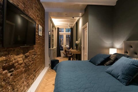 Big and comfy king sized bed with wall mounted TV