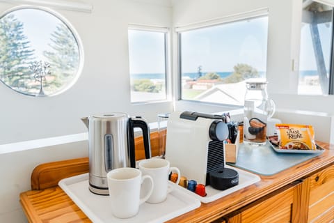 Coffee maker, coffee pods, kettle, cereal + milk & juice in the fridge
