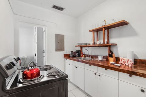 Spacious kitchen stocked with cookware, dishes, and essentials