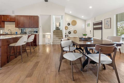 The kitchen is open to the front door and dining table.