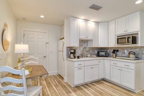 The kitchenette is equipped with a refrigerator and freezer, microwave, coffee maker, toaster oven, and an electric cooktop.