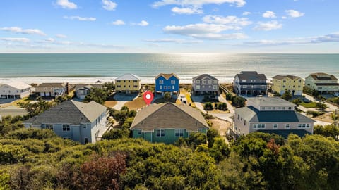 Coastal community featuring beachfront vacation homes with direct ocean access and pristine sandy shoreline.
