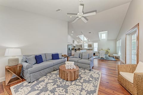 Unwind in this bright, airy living space where coastal comfort meets modern elegance with soaring ceilings and natural light.