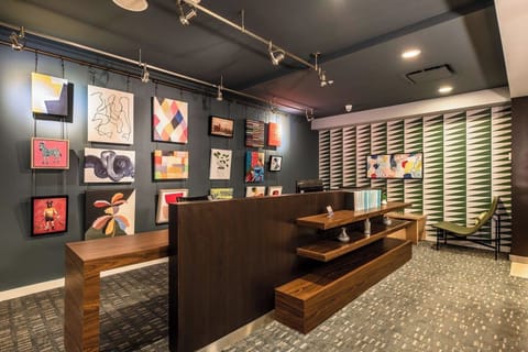Unwind beneath curated art in a stylish, welcoming lounge.