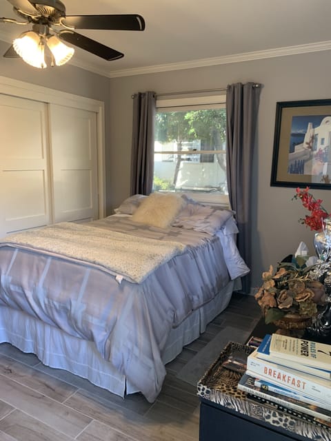 Comfortable queen bed in bedroom with private entrance.