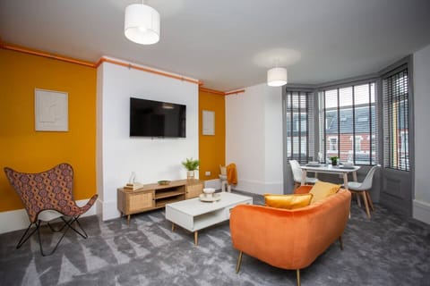 The living room bursts with lively hues, adorned with colorful décor that breathes life into every corner.