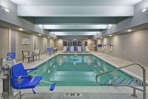 Recharge poolside with calm water and comfortable deck seating.